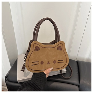 Close-up of cat-shaped crossbody bag with detailed embroidery and premium leather handles