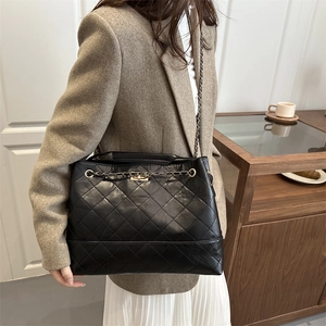 Black quilted faux leather tote bag with gold chain strap and large capacity