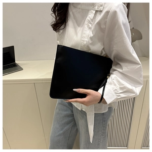 Minimalist black faux leather envelope clutch with gold zipper and wrist strap detail