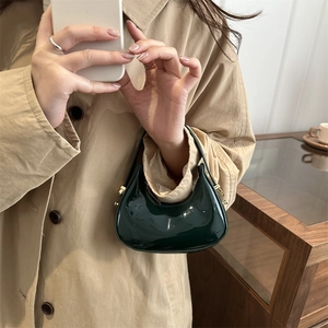 Minimalist dark green patent leather hobo mini bag with glossy finish and gold metal clasp