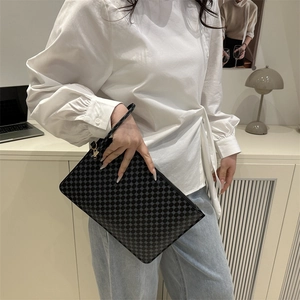 Pochette noire minimaliste pour femme avec motif géométrique et fermeture éclair dorée