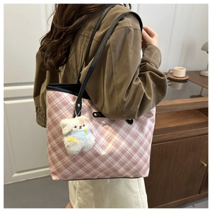 Close-up of pink and white checkered tote bag with a cute white plush bear pendant
