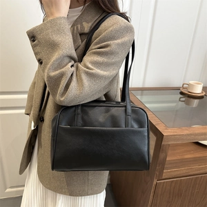 Minimalist black faux leather tote bag with large capacity and thin shoulder straps