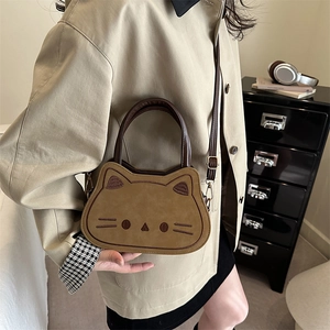 Retro cat-shaped crossbody bag in khaki suede featuring cute whiskers and top handle
