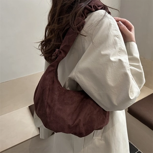 Retro dark brown velvet hobo bag with pleated shoulder strap shown on a model