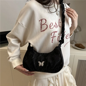 Fashionable black pleated crossbody bag with silver butterfly buckle and ruffled strap