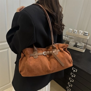Minimalist brown suede tote bag with decorative buckle strap and spacious interior