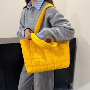 Quilted yellow puffer tote bag with wide padded strap for 2025 autumn winter fashion