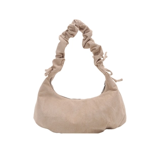 Beige faux suede dumpling shoulder bag with scrunchie strap and side ribbon bows