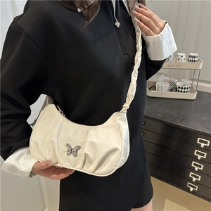 Chic beige crescent underarm bag with silver butterfly buckle and ruched strap details
