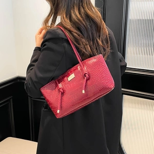 Deep red crocodile pattern underarm bag with knot strap and golden metal logo plaque