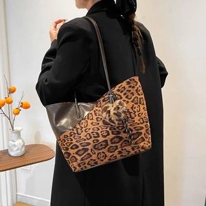 Retro leopard print tote bag with heart charm and slim shoulder strap on model