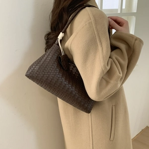 Dark brown woven leather hobo bag with intrecciato texture and sleek shoulder strap