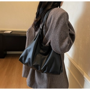 Close-up showing the soft matte leather texture and drape of this minimalist hobo bag