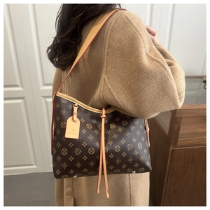 Fashionable brown monogram bucket bag shown styled with a classic beige wool coat