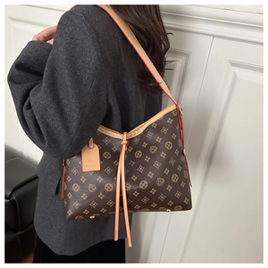 Close-up of vintage monogram tote bag with contrast straps and metal bottom studs