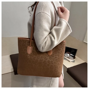 Close-up of brown leopard print tote bag in soft suede fabric with slim shoulder straps
