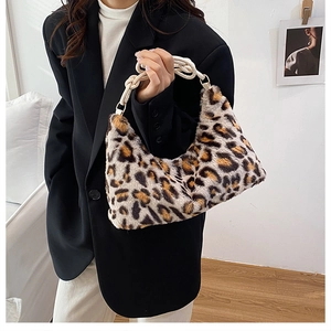 Detail of leopard print faux fur handbag with braided cotton rope handle and metal rings