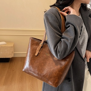 Retro dark brown leather tote bag with elegant shoulder straps for women's daily commute