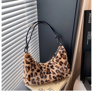 Detailed close-up of leopard print plush hobo bag with sleek black knotted straps