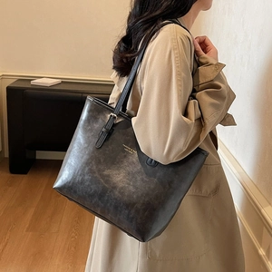 Minimalist vintage dark grey tote bag in textured leather with thin shoulder straps