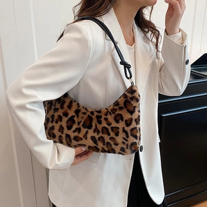 Leopard print faux fur underarm bag with crescent shape and black leather strap