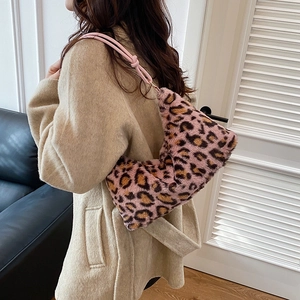 Pink leopard print plush shoulder bag styled with a minimalist beige winter coat