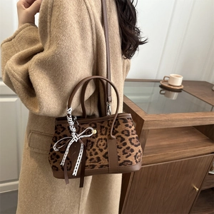 Retro leopard print crossbody handbag with brown leather trim and lace bow decoration