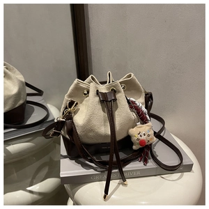 Detail of minimalist bucket bag showing matte fabric texture and Tidal Dream branding