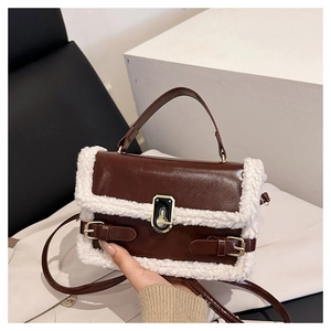 Close-up of brown faux leather shoulder bag with white faux shearling trim and gold lock