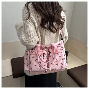 Pink cherry print tote bag featuring dual front zip pockets and adjustable shoulder strap