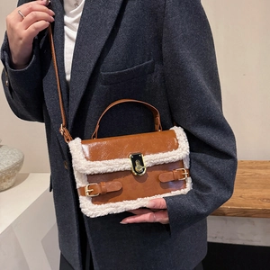 Brown faux leather shoulder bag with white faux fur trim and gold buckle closure