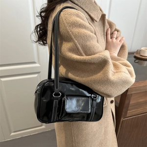 Chic black glossy square shoulder bag with white contrast stitching for elegant winter outfits