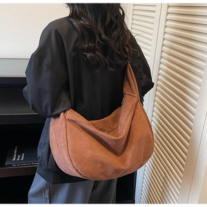 Close-up of brown suede hobo bag showing large capacity and textured fabric