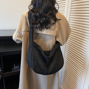Minimalist black canvas crescent crossbody bag with wide shoulder strap for women