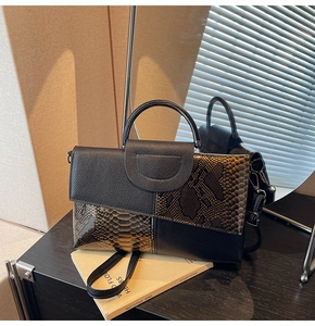 Detail of the high-quality snake pattern stitching and lychee leather texture on the bag