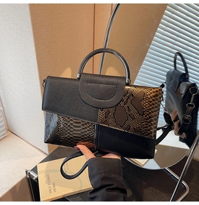 Detail of snake skin texture and pebbled leather stitching on this chic handbag