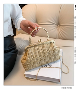 Detail of woven champagne evening bag with gold floral metal handle and clasp closure