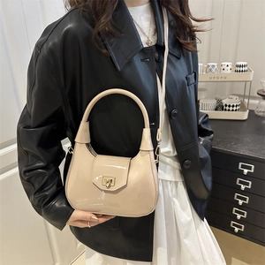 Minimalist beige patent leather dumpling crossbody bag with gold lock for women