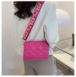 Detail of rose pink quilted crossbody bag with stylish patterned wide shoulder strap