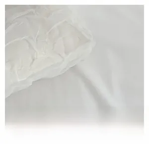 Macro detail of white pleated fabric with rich textured ripples on the shoulder bag