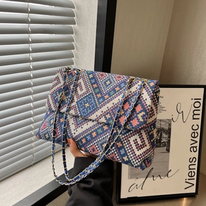 Ethnic knit shoulder bag with blue diamond pattern and gold metal chain strap