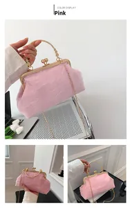 Detail of pink lace handbag featuring gold metal handle and elegant tulle ruffle textures