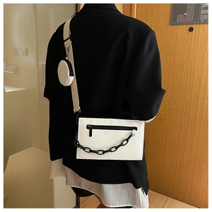Detail view of stylish white PU square bag with black acrylic chain and small round coin purse