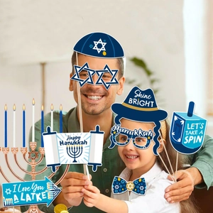 Father and daughter using Happy Hanukkah party photo booth props with blue Star of David
