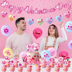 Detailed view of Valentine's Day party set with pink banner, balloons and cake toppers