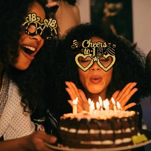 Women wearing black and gold 18th birthday party eyewear with glitter finish and cake