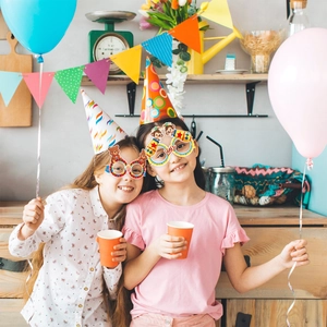 Kids carnival party paper glasses with circus monkey and star designs for birthday fun