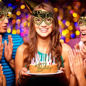 Close-up of sparkling gold glitter Cheers to 21 birthday party glasses worn by a person
