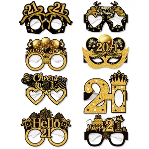 Detail view of 8-piece black and gold glittery 21st birthday photo booth glasses